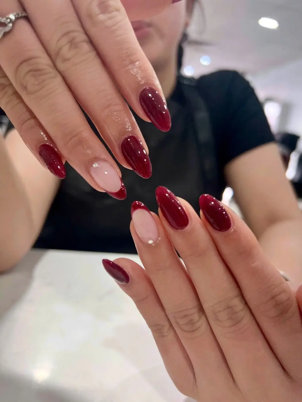 Glossy burgundy almond nails done at HAPPY Beauty & Nailspa